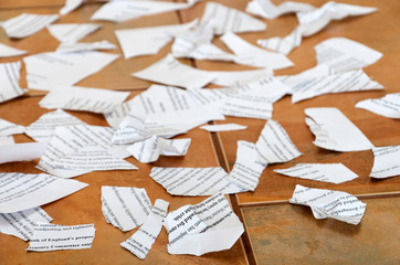 Scraps of papers on tiled floor