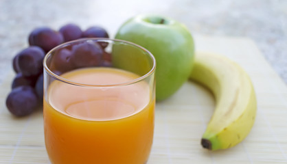 fruits and juice on a granite table