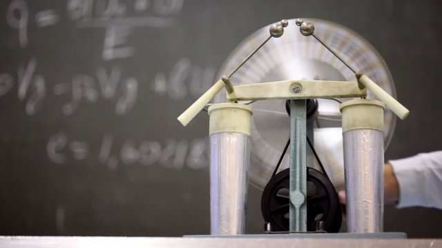 Man rotates Wimshurst influence machine