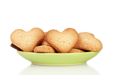 Heart-shaped cookies on green plate isolated on white