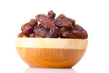 delicious dried dates in wooden bowl isolated on white