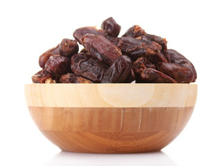 delicious dried dates in wooden bowl isolated on white