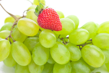 bunch of white grapes and strawberries isolated on white