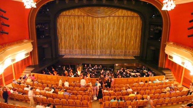 In big theatre many people take places for viewing