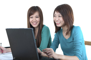 Two Asian female student studying and using computer