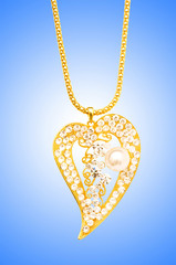 Golden jewellery against gradient background