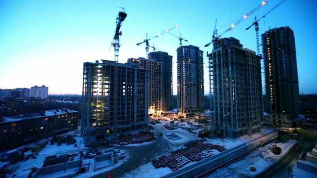 construction site in foreground of dormitory area cityscape