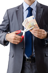 Man cutting money on white