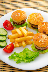 Plate with tasty mini burgers