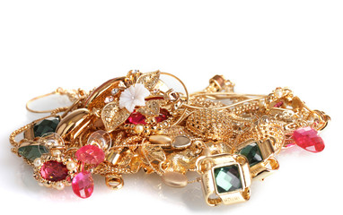 Various gold jewellery isolated on white