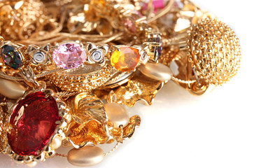 Various gold jewellery isolated on white