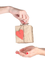 Fototapeta premium Man's hand giving parcel with blank heart-shaped label to woman
