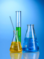 Three flasks with color liquid with reflection
