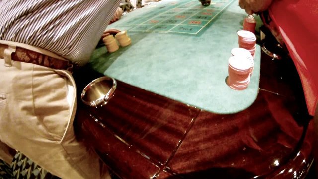 People sit at table with chips and stake