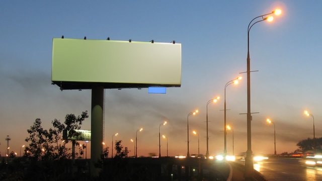 publicity board on road roadside, cars quickly go on highway