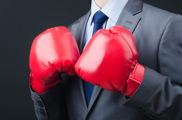 Young businessman with boxing gloves