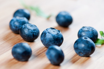 Large blueberries on a wooden board close up