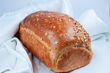 loaf of bread on white satin fabric