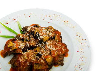 Meat under tasty sauce in plate