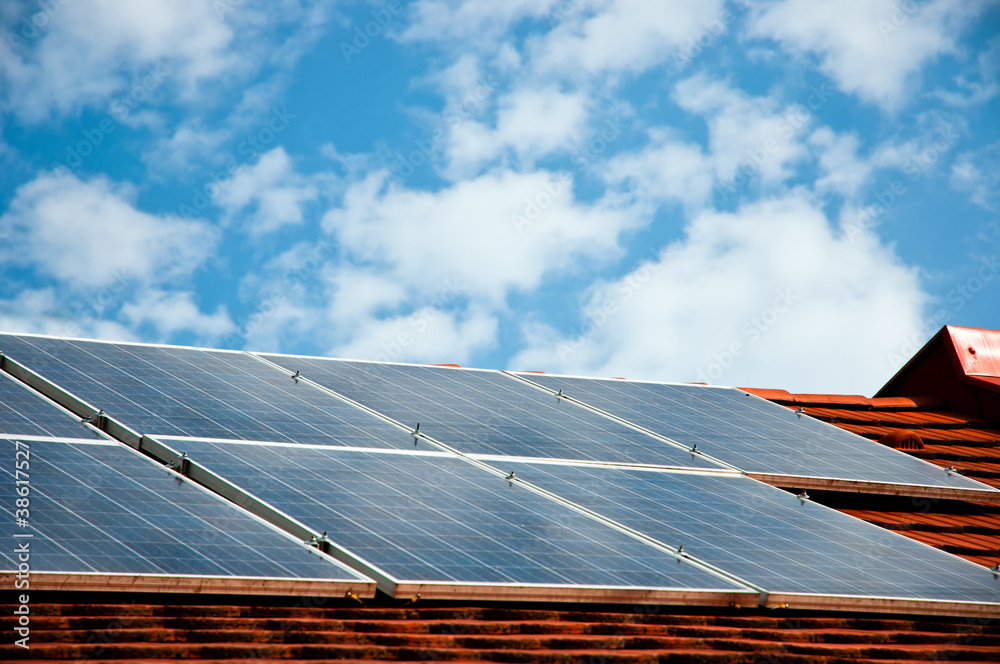 Wall mural cells of solar energy panels on the roof of a building