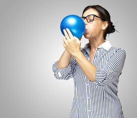 woman blowing balloon