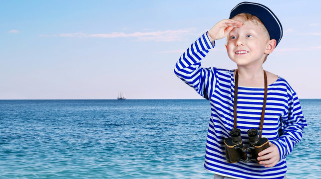 Little ship boy with binocular in hands