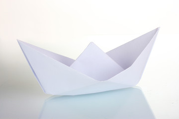 Origami paper boat isolated on white