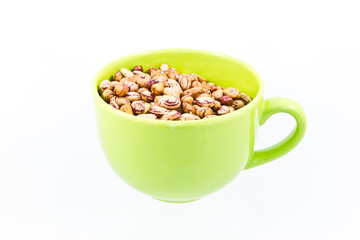 Beans in green bowl isolated on white
