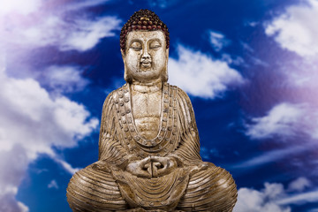 Fototapeta na wymiar Buddha and blue sky background