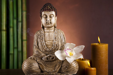 Buddha statue with orchid flower