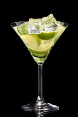 glass of cocktail with lime and mint on black background