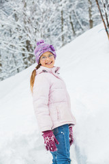 Fototapeta na wymiar winter girl throwing snowball