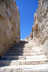 Fototapeta premium A stone stairway up against the blue sky