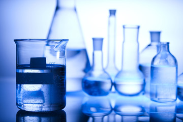 Glass laboratory equipment with blue background