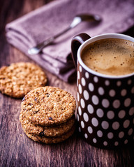 Wholemeal cinnamon cookies and mug of coffee