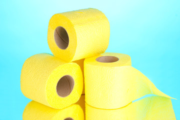 yellow rolls of toilet paper on blue background