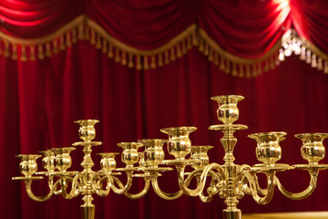 Antique candelabra with red background