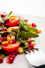 Tuna salad with rucola, tomatoes, sweet corn, cashew nuts and p