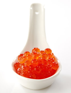 red caviar in white spoon