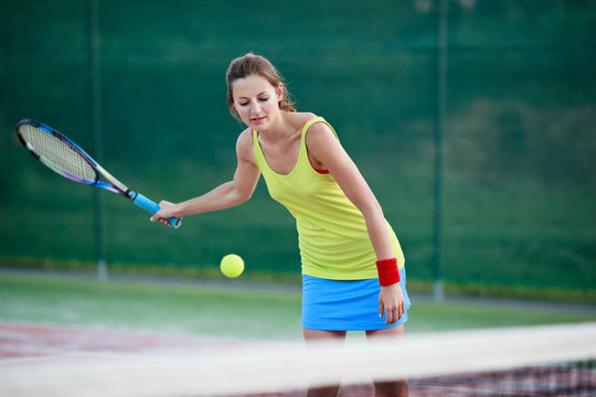 pretty, young female tennis player on the tennis court