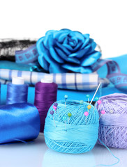 bright blue yarn, fabric, satin ribbon and measuring tape