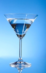 Glass of water on blue background