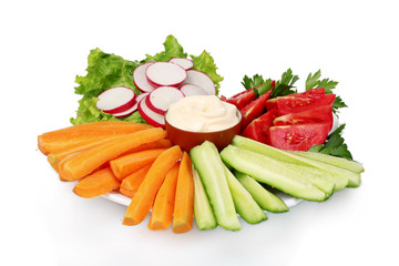 Chopped vegetables and sauce on plate isolated on white