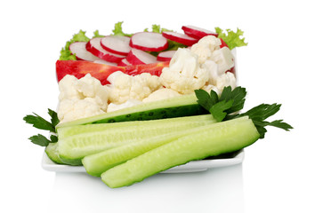 Chopped vegetables on plate isolated on white