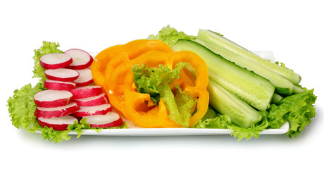 Chopped vegetables on plate isolated on white