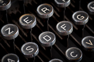 Old typewriter keyboard with silver and black round keys backgro