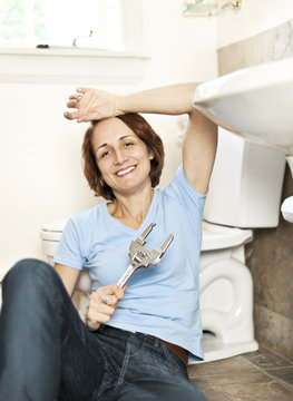 Woman fixing plumbing