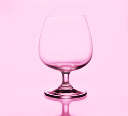 Brandy glass on pink background