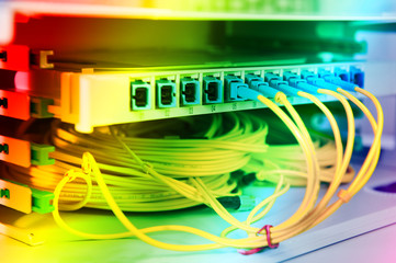 Fiber Optic cables connected to an optic ports and Network cables connected to ethernet ports