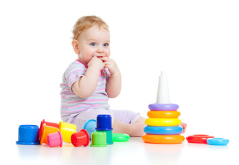 Cute little boy playing colorful toys isolated on white